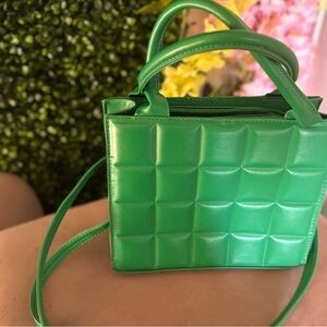 Green leather square panel purse with strap and gold accents